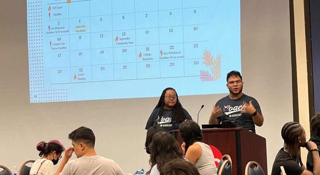 Two UIC transition coaches shown presenting to a group of UIC Flames Leadership Network students