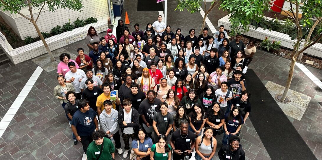 Group photo of members of the Flames Leadership Network. Overhead view of students in the first floor atrium area of the Student Services Building.